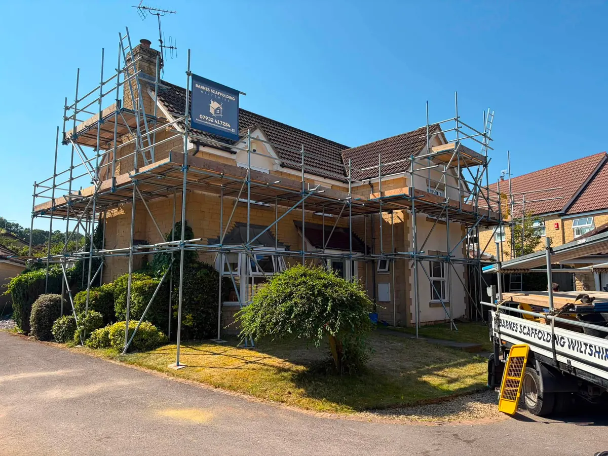 Scaffolded house with the Barnes Scaffolding Wiltshire truck parked outside